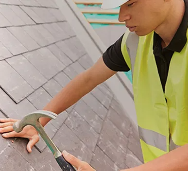 man repairing roof cambridge